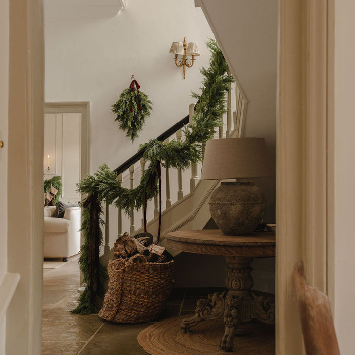 Christmas greenery styled in a hallway