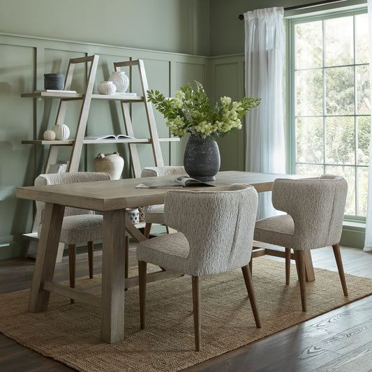 Dining room with wooden table and chairs, shelves, and a large window.