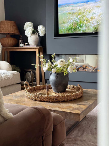 Living room with a coffee table, sofa, and decorative elements.