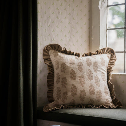 Decorative pillow with floral pattern on a window seat