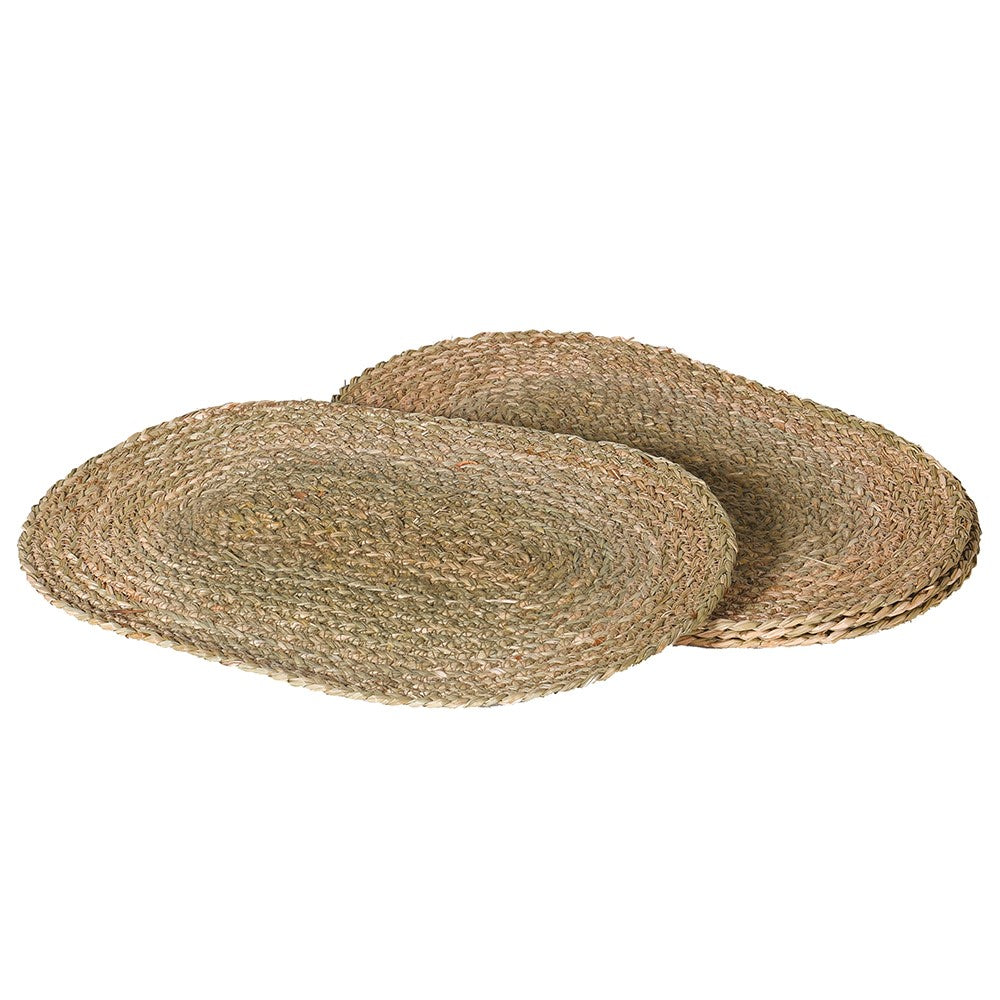 Two round woven placemats on a white background