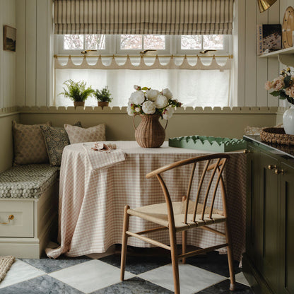 Nestled nook with a table, chairs, and decorative elements in a home setting.