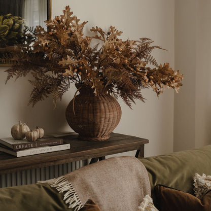 Large oak leaf and acorn branch styled in rattan vase