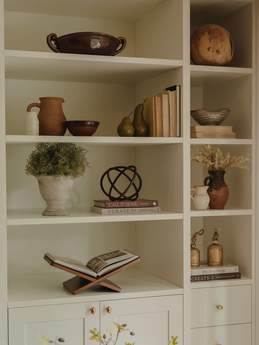 Metal ring ornament styled on shelf with candles and decor